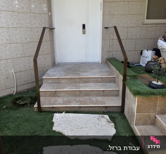 כניסה לבית עם מדרגות ודלת לבנה